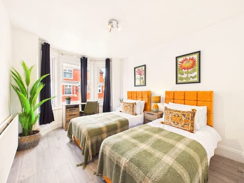 This beautifully styled bedroom combines comfort with a cheerful design, making it the perfect restful retreat for friends, siblings, or solo travelers. Flooded with natural light from large windows, balanced by elegant dark privacy curtains for a peacefu