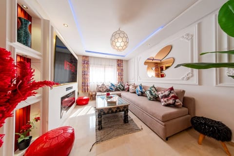 Relax in the stylish living room featuring elegant decor, a cozy sofa, and a smart TV for your entertainment.
