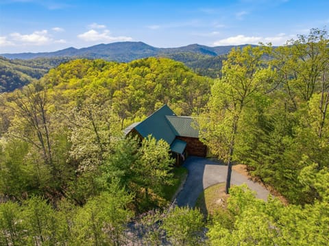 Secluded mountain cabin nestled among rolling hills and lush forest, surrounded by pristine Appalachian wilderness.