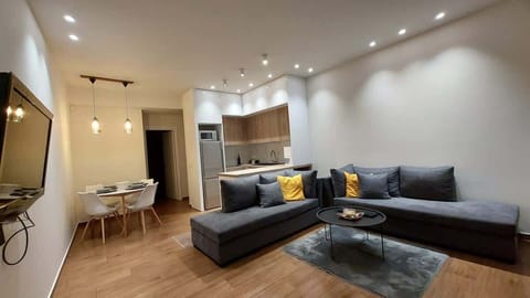 The living area opens up with a large L-shaped sofa, warm recessed lighting, and a calm neutral palette that makes it easy to settle in after a day at the beach or out exploring the sites.