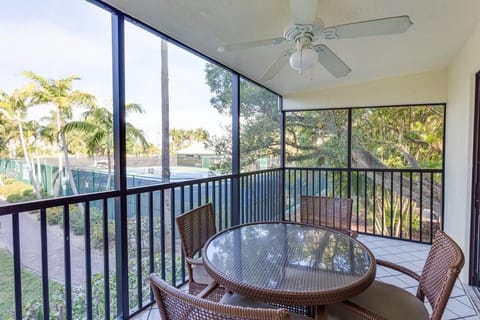 Sip morning coffee on the screened balcony surrounded by palms