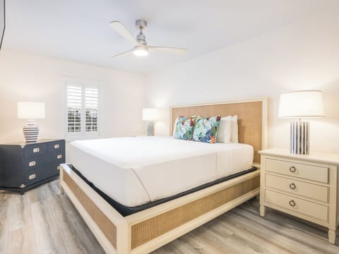 Unwind in crisp linens under a breezy ceiling fan.