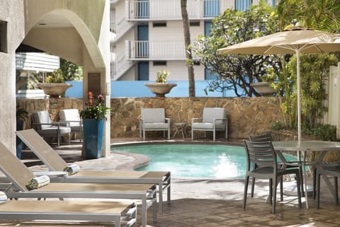 Unwind poolside on cushioned loungers in warm island sunshine.