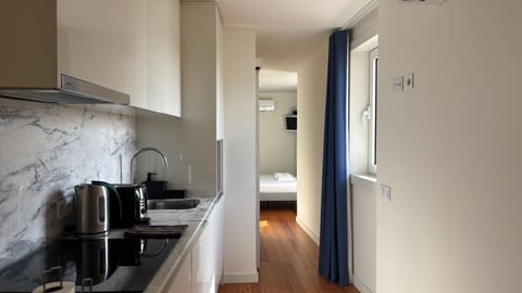Sleek and compact kitchen design with modern appliances, seamlessly leading into a bright, thoughtfully laid-out studio space.
#PortoStay #ModernLiving #StudioDesign #CityBreakPorto #TravelPortugal