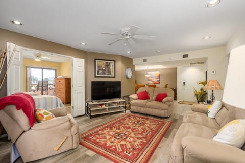 Spacious living room with cozy seating and vibrant accents
