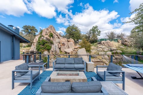 Outdoor living at its best.  Comfortable seating around a gas fire pit on the spacious deck overlooking dramatic natural rock formations and mature trees.