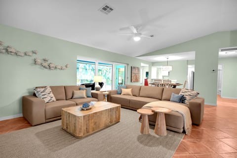 Open living room. complete with a 65" smart TV ready to stream whatever services you use! Leather couch and love seat, open and airy.