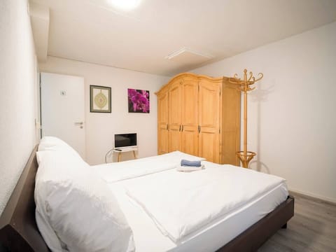 Spacious bedroom with comfortable bed and large wardrobe