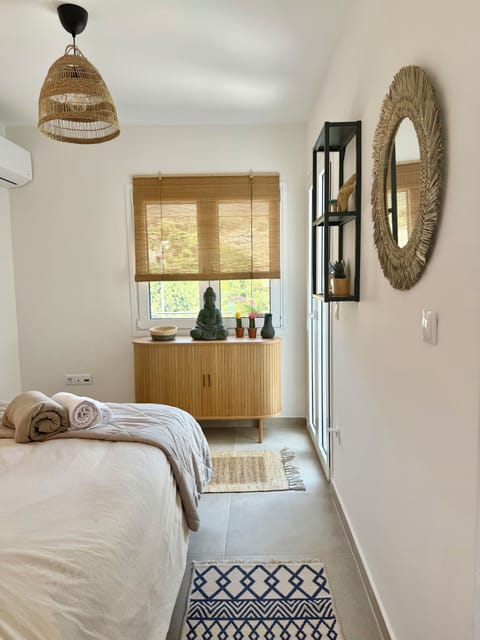 Cozy bedroom equipped with linen, towels, wardrobe, and air conditioning. 