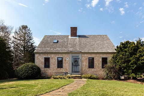 Classic Eastham exterior with cedar shingles, a welcoming front entry, and timeless Cape Cod curb appeal.