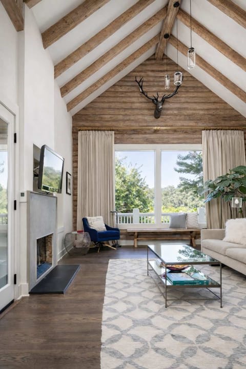 Stunning vaulted living room with open beams and abundant natural light - an inviting space to relax, unwind, and enjoy cozy wine country evenings.