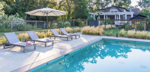 Sun-drenched poolside oasis with lounge seating and serene garden views - perfect for slow mornings, afternoon dips, and golden-hour relaxation.