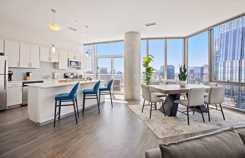 Host memorable dinners beside wraparound windows and skyline scenery.