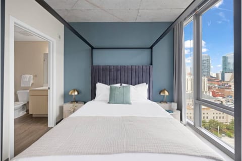 Wake up to skyline views from a plush, design-forward bed.