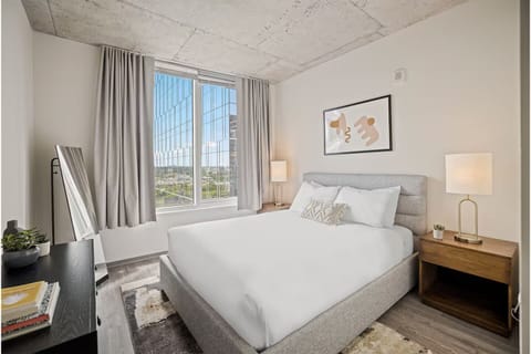 Recharge on crisp linens in a calm, sunlit bedroom.