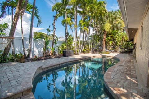 Private saltwater pool—gentler on skin and eyes, surrounded by mature palms.