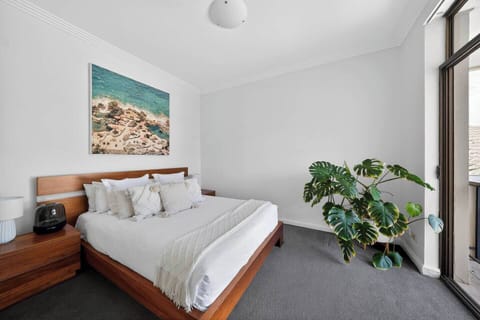 Unwind in the primary bedroom with a queen bed, built-in storage, and a calm setting designed for restful nights.