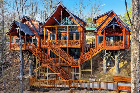 Stunning multi-level treehouse retreat with connecting bridges and decks, nestled among tall trees for an unforgettable forest escape.