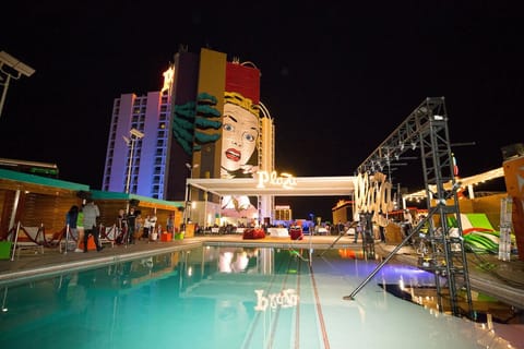 Celebrate vibrant evenings poolside with dazzling neon city energy.