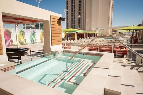 Unwind in bubbling hot tub comfort beside the sparkling pool.