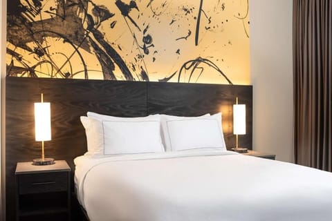 Drift off fast with plush pillows and warm bedside lighting.