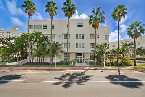 Arrive at a classic Art Deco facade framed by palms.