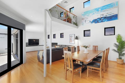 Expansive open-plan living and dining area with soaring ceilings and abundant natural light.