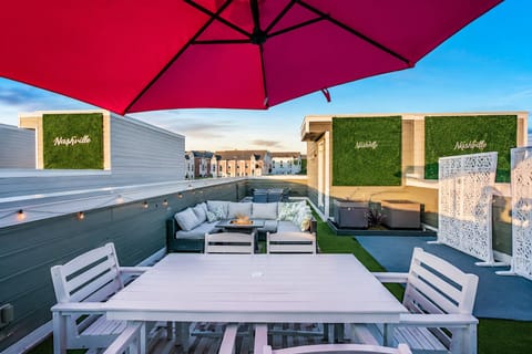 Rooftop lounge with cozy seating and vibrant shade