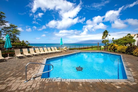  Where poolside calm meets patio bliss—relax in island elegance, just moments from the shoreline   