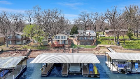 Waterfront retreat with private boat slips and lakeside setting, surrounded by peaceful residential community.