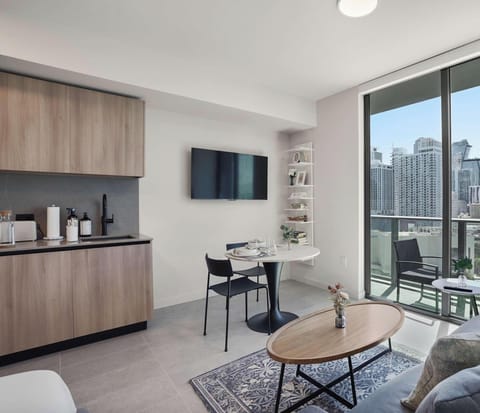 Bright studio with queen bed and floor-to-ceiling city views