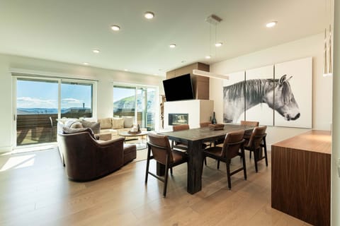 Bright open-concept living and dining area with mountain views