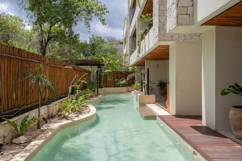 Tropical pool surrounded by lush greenery 🌿💧
