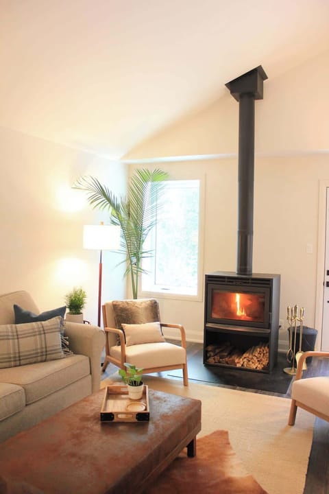 Living room with ample seating, wood burning fireplace. 