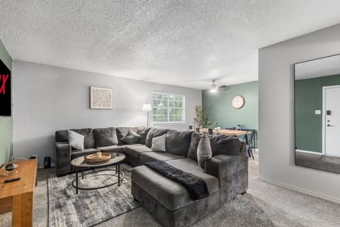 Spacious and inviting living area with comfortable seating and a smart TV, perfect for relaxing after exploring Arlington or attending events at AT&T Stadium.