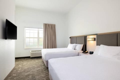 Unwind in crisp, hotel-style beds with soft natural light.