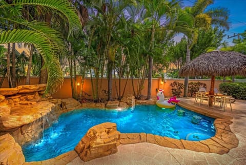 Pool with waterfall & tiki hut