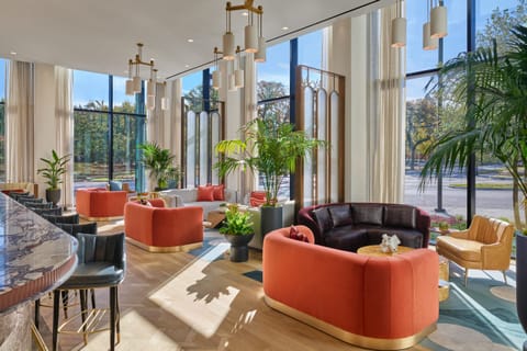 Unwind in sunlit lounge seating with expansive garden views.