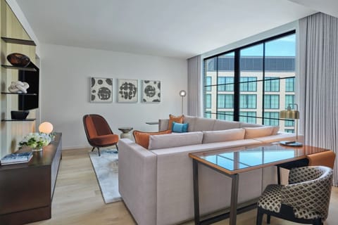 Unwind on the plush sofa beside expansive city views.