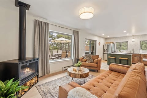 Cozy upstairs living room with gas fireplace and leather Article furniture.