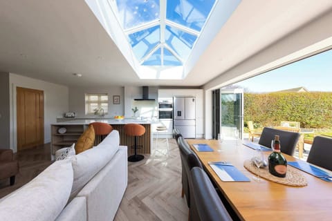 Bright open-plan living with skylights and garden access through bi-fold doors.