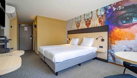 Recharge in a sleek room with crisp linens and warm lighting.
