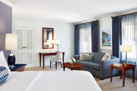 Unwind in a spacious bedroom with cozy seating nook.