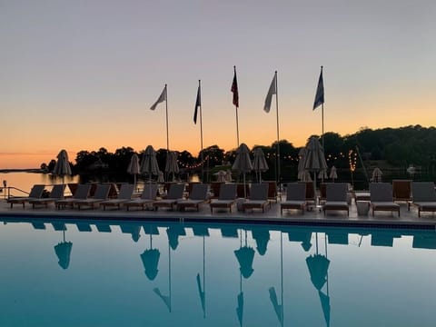 Unwind at sunset as the pool mirrors a glowing sky.