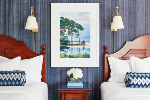 Drift off in cozy double beds under warm, inviting lighting.