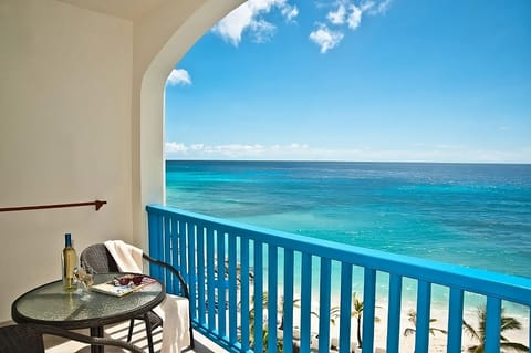Sip morning coffee on your balcony above the waves.