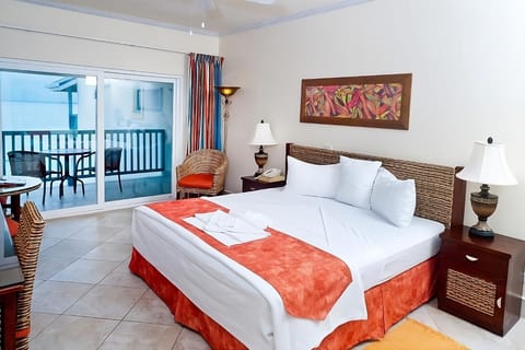 Recharge in a cozy king bed with private balcony seating.