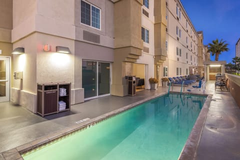 Relax after dark in a softly lit pool oasis.