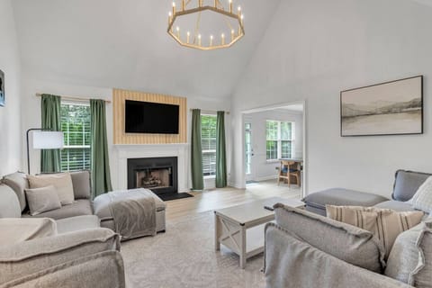 Inviting main level living room with a smart TV and plenty of seating.