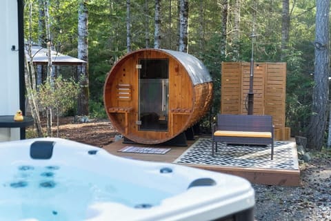 The Sauna is powered by an electric stove that reaches over 140 degrees. The Hot tub is set at 102 degrees. The outdoor shower is hooked up to the hot and cold water spout on the opposite side of the house. You can adjust the temp of the water there.